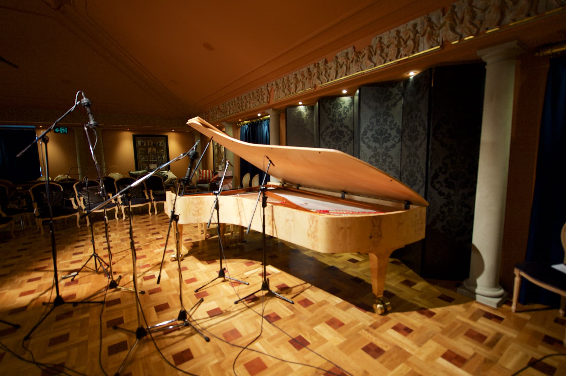 Grand piano set with recording microphones in the concert salon